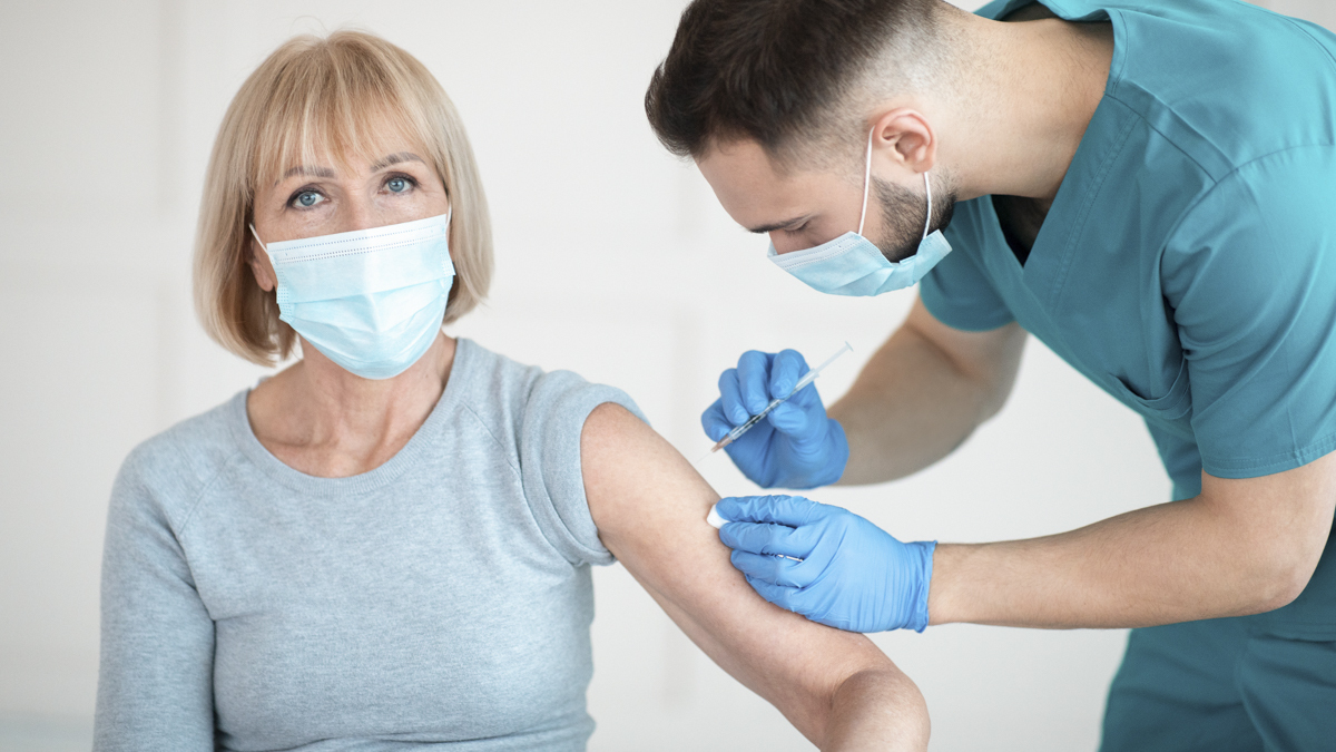Women recieving a vaccine from a nurse