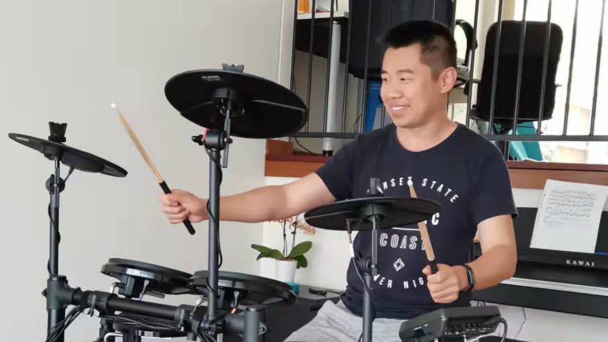 Dr David Zheng on his drum kit at home